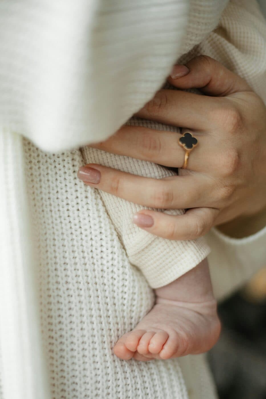 A parent holding their newborn close