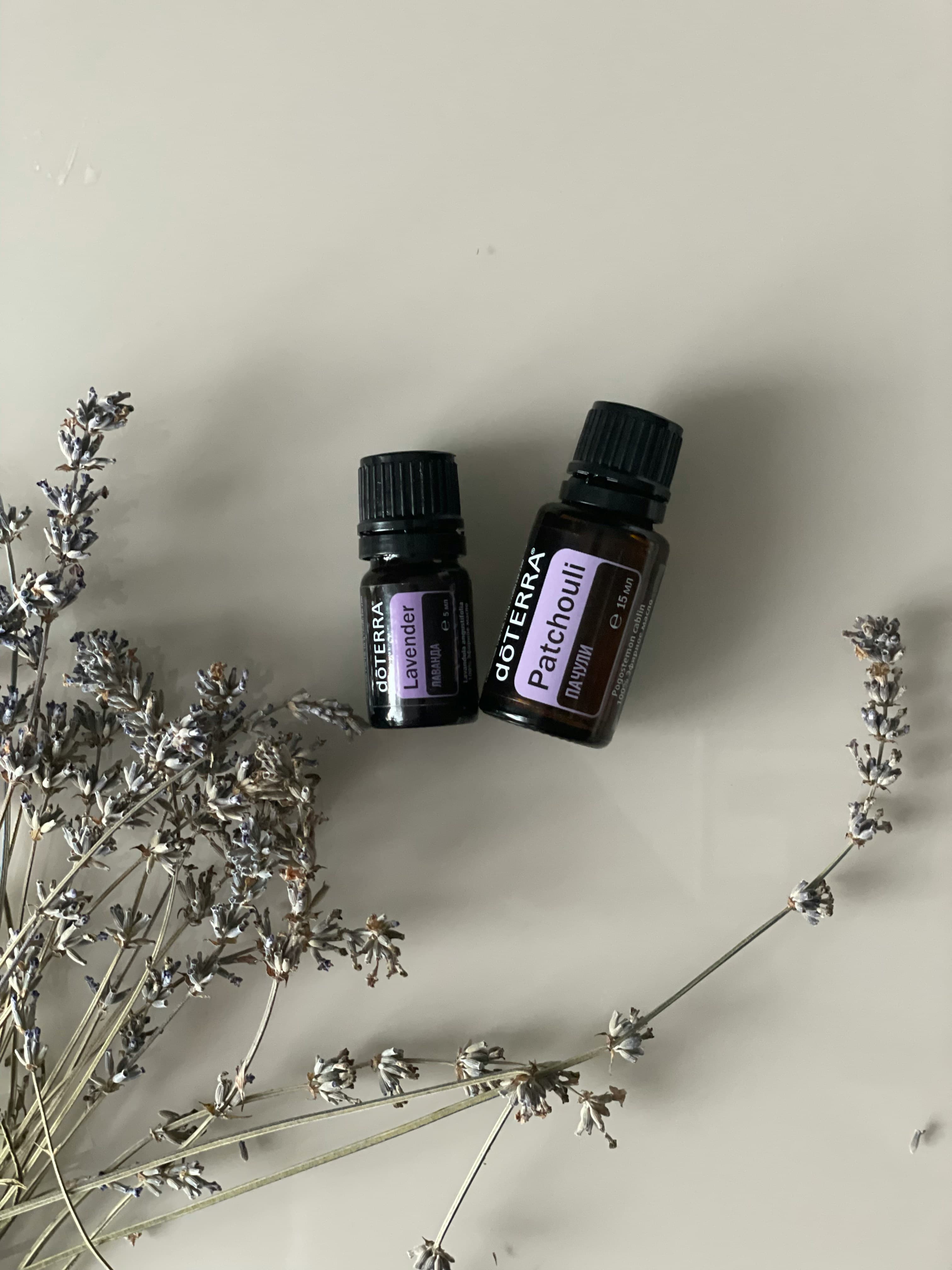 Lavender and patchouli massage oils with sprigs of dried lavender
