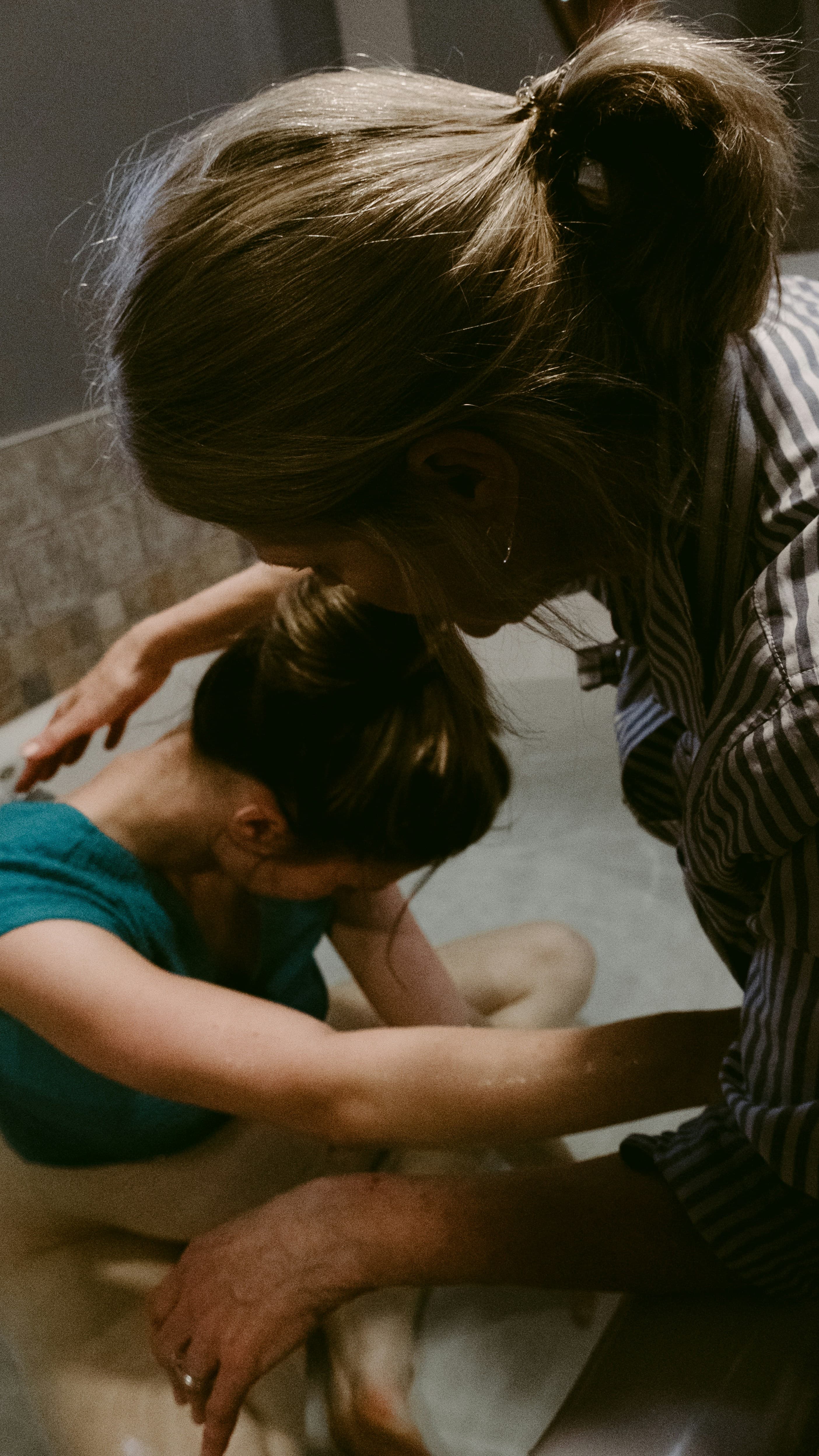 A midwife tending to a labouring woman